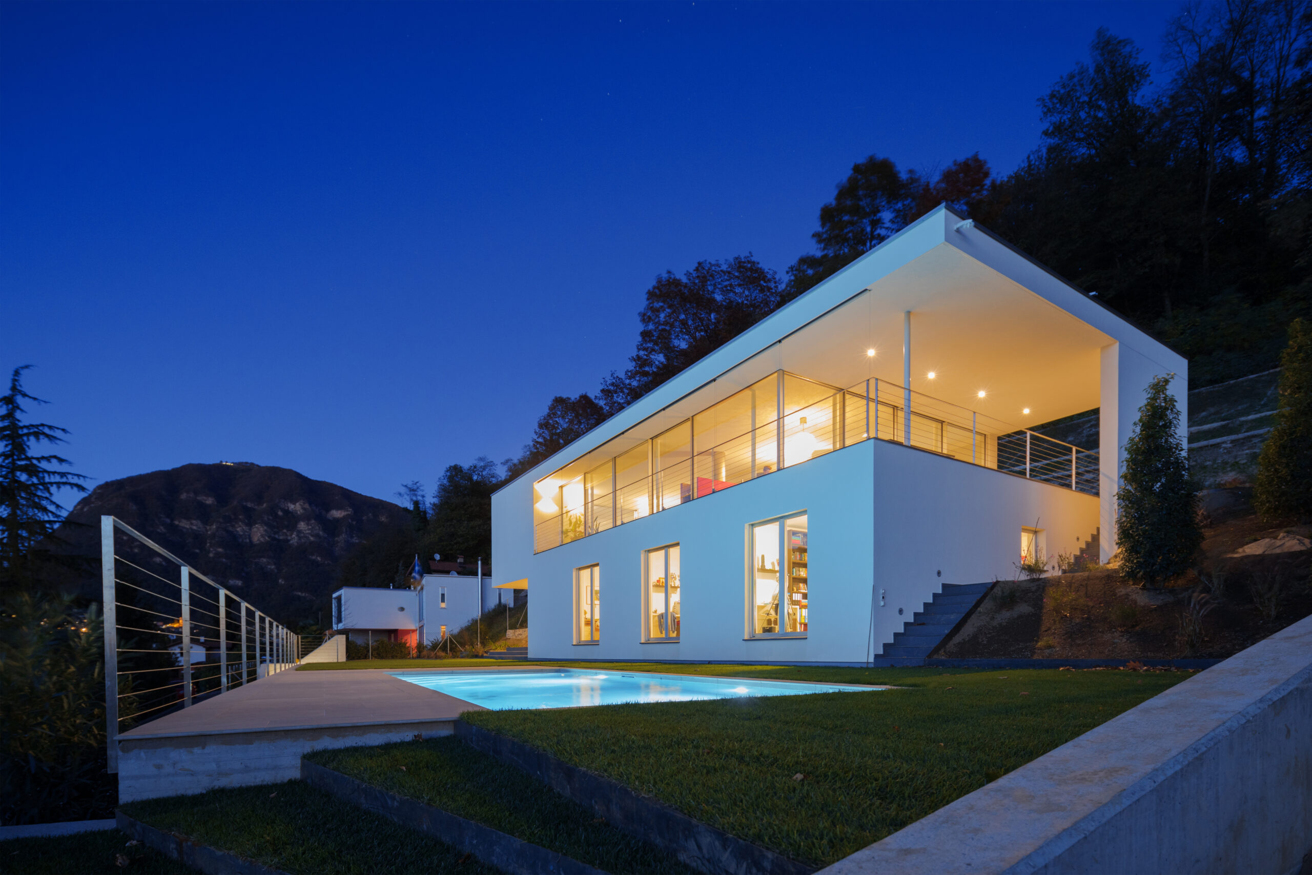Modern villa, exterior in the night, lights on
